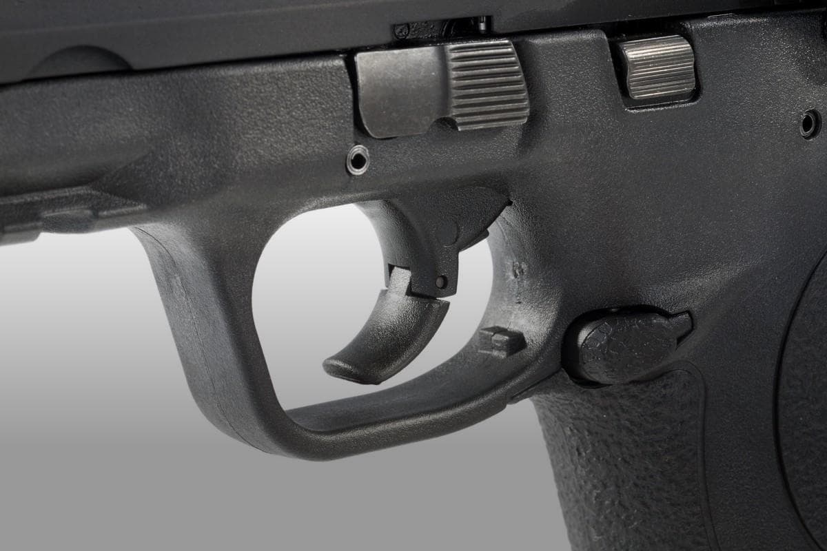 an image of a gun focusing on its trigger